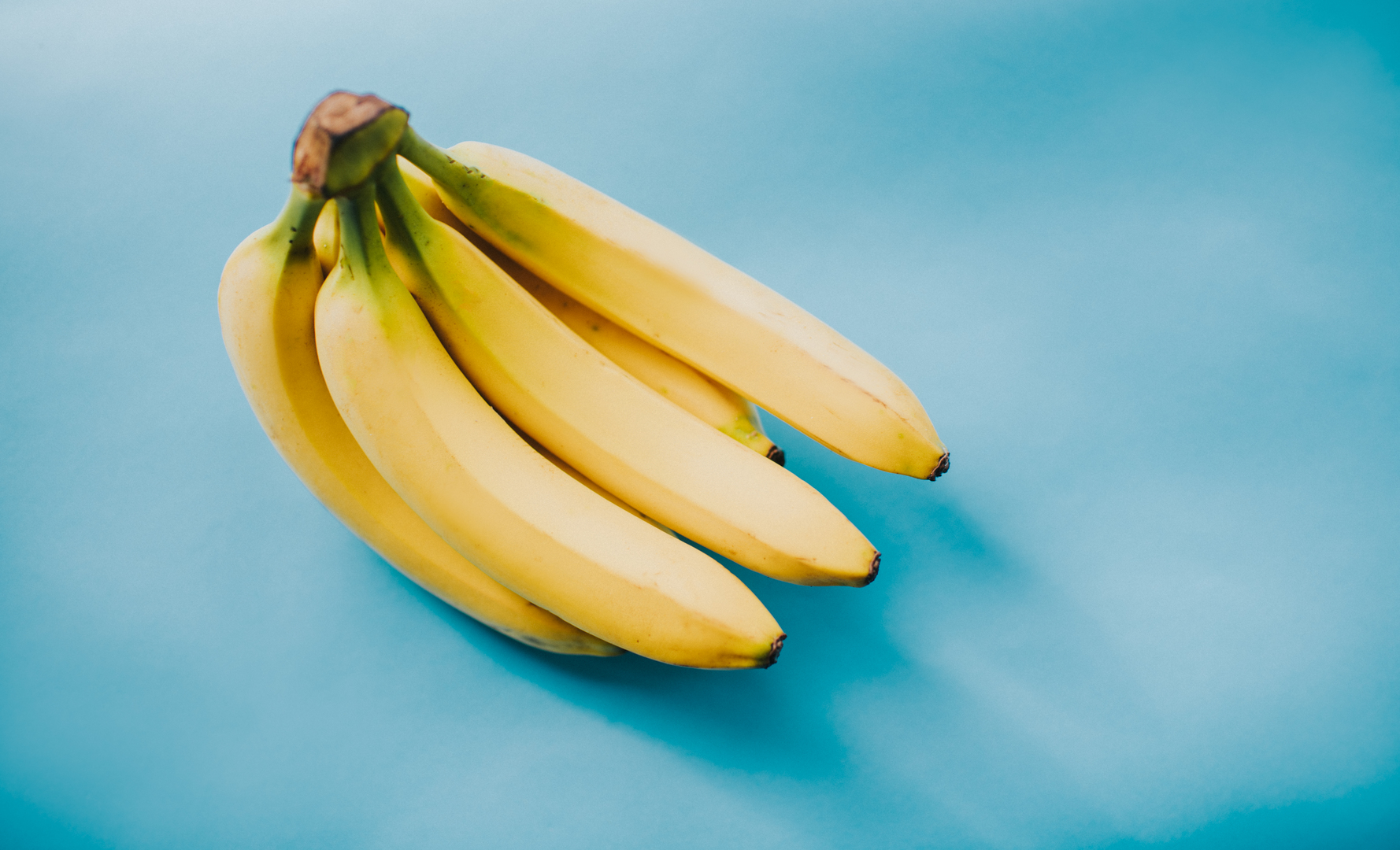 Bunch of bananas on a blue background.