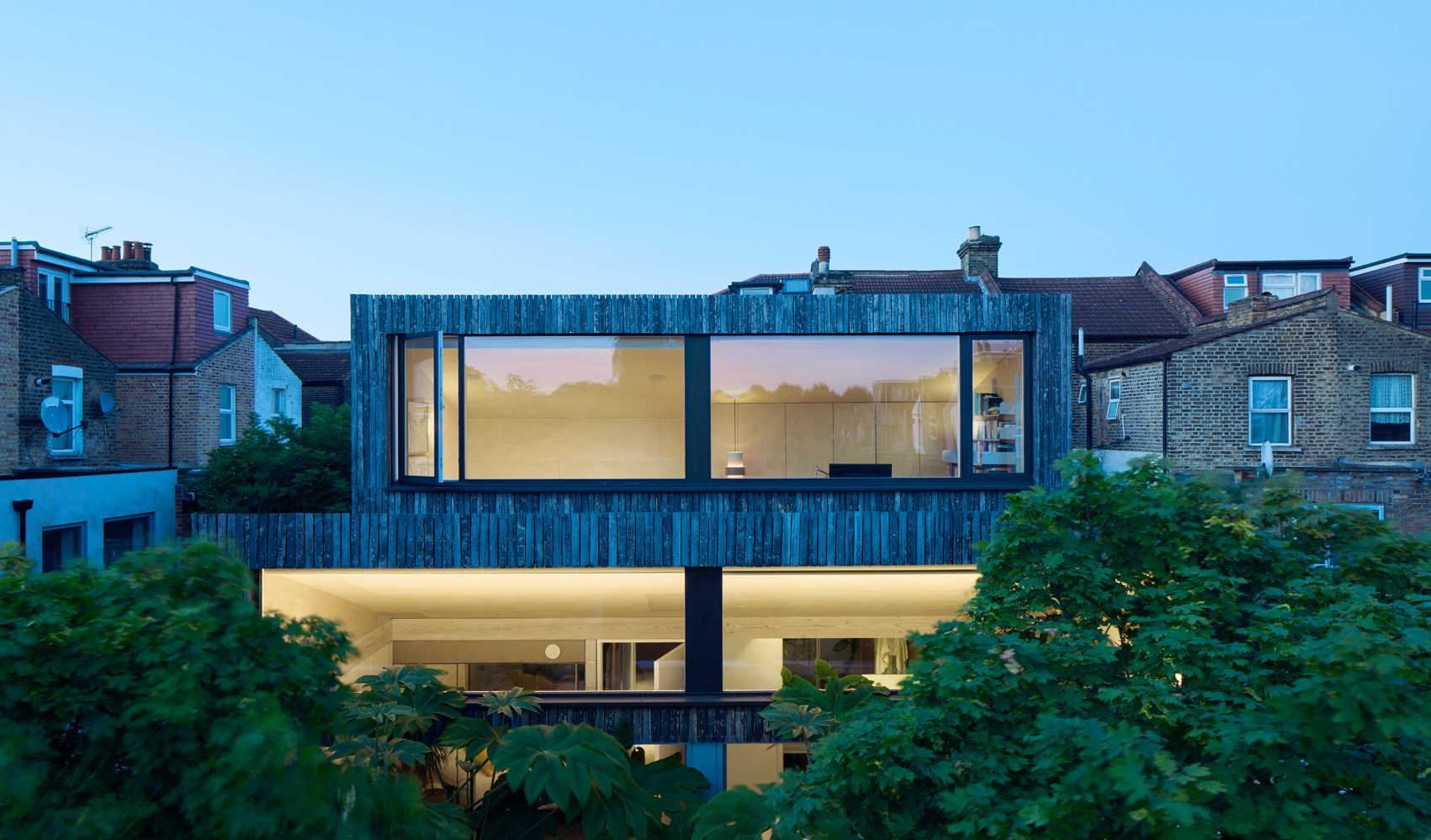 Modern home extension at dusk.