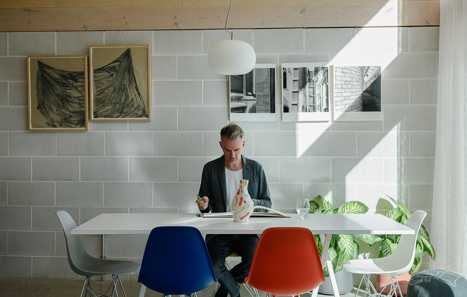Architect Mark Shaw at a table reviewing papers.