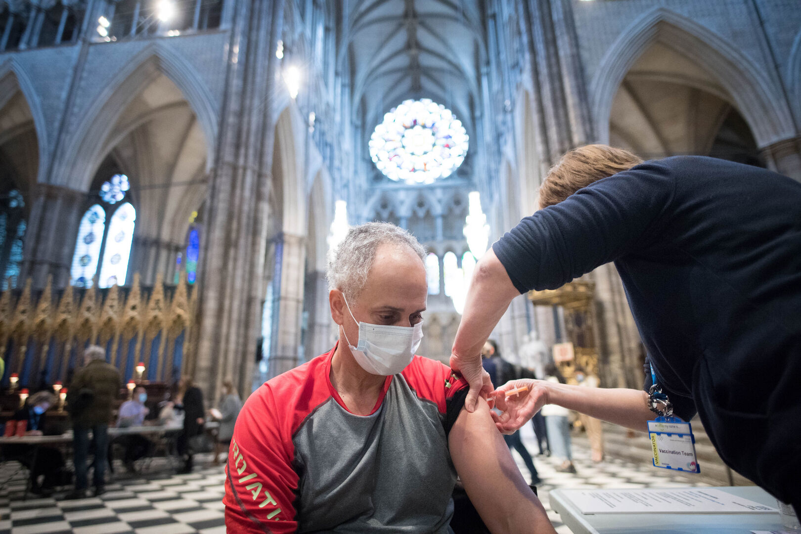 A person receiving a COVID-19 vaccine injection at Westminster Abbey.