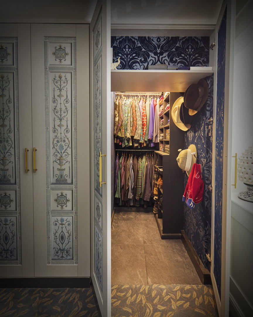 Mr. Ben-inspired wardrobe with patterned wallpaper and bespoke carpet.