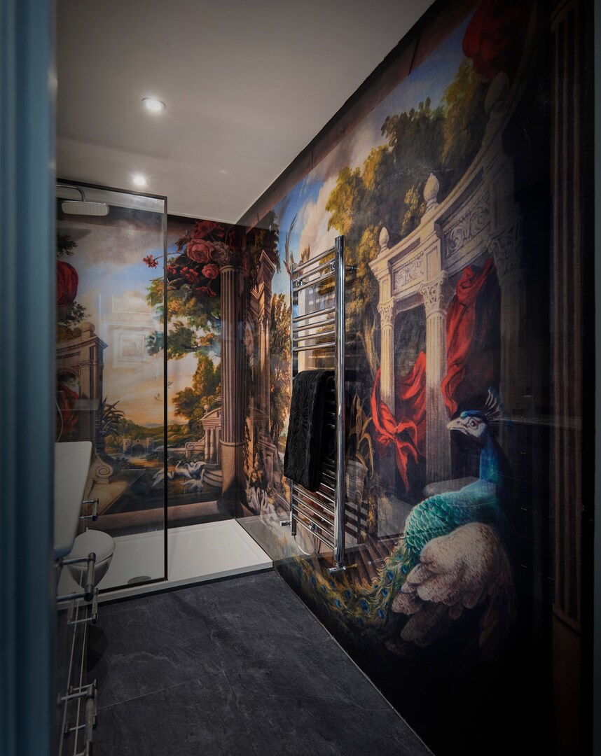 Shower room with Renaissance-style wall mural and peacock.